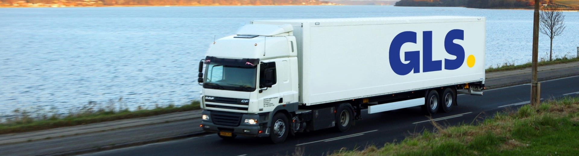 A GLS trailer drives by the water